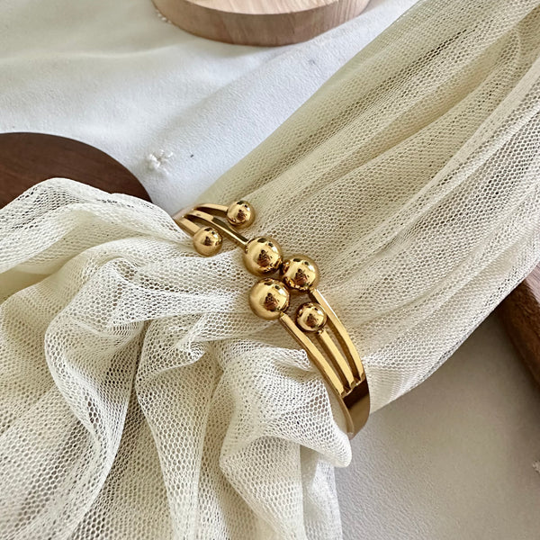 Gold Comets striking bracelet